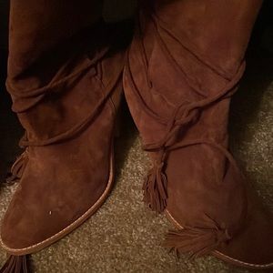 Women boots with wrap around ankle tassels.